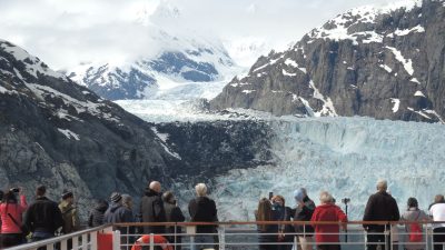 tourists viewing majestic glacier from cruise ship deck