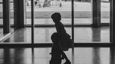 children silhouette in airport terminal
