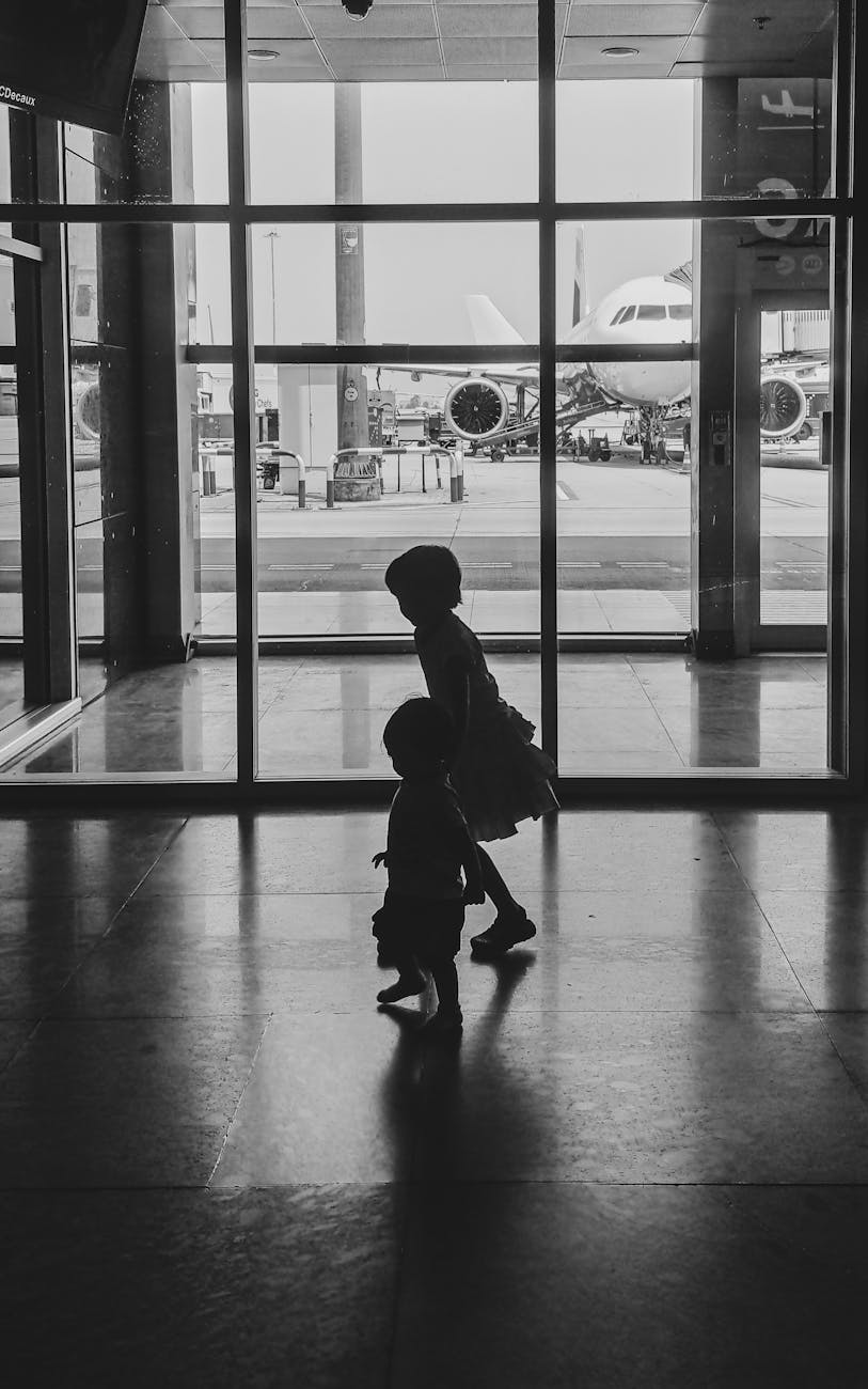 children silhouette in airport terminal