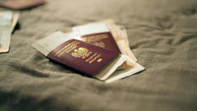 polish passport and travel documents on bed surface