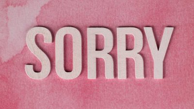 apology concept with pink watercolor background