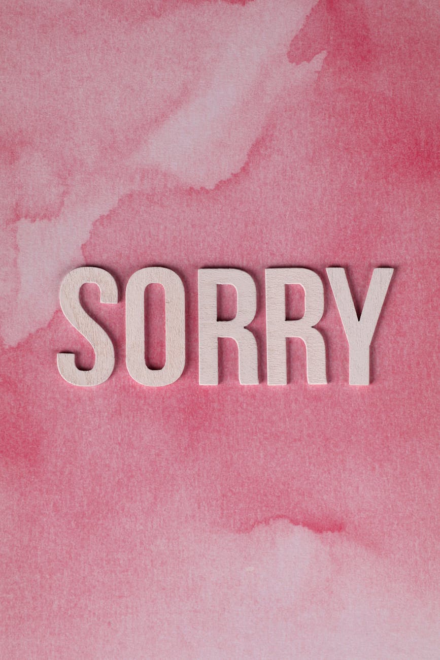apology concept with pink watercolor background