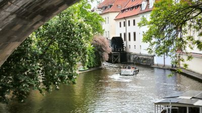 scenic river view with boats under stone bridge