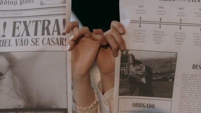 couple holding newspapers with romantic headlines