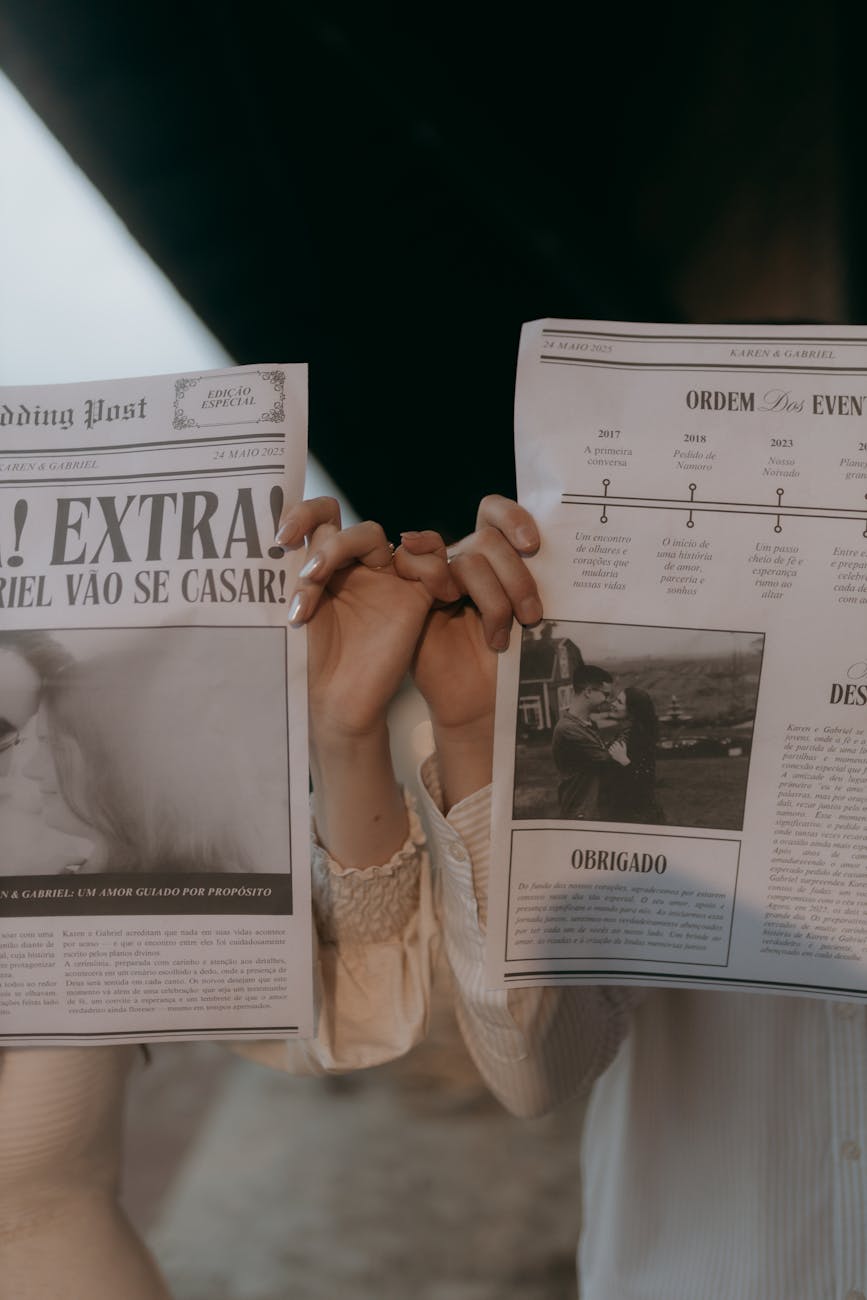 couple holding newspapers with romantic headlines