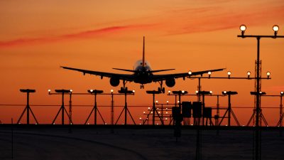 airplane landing at sunset silhouette scene