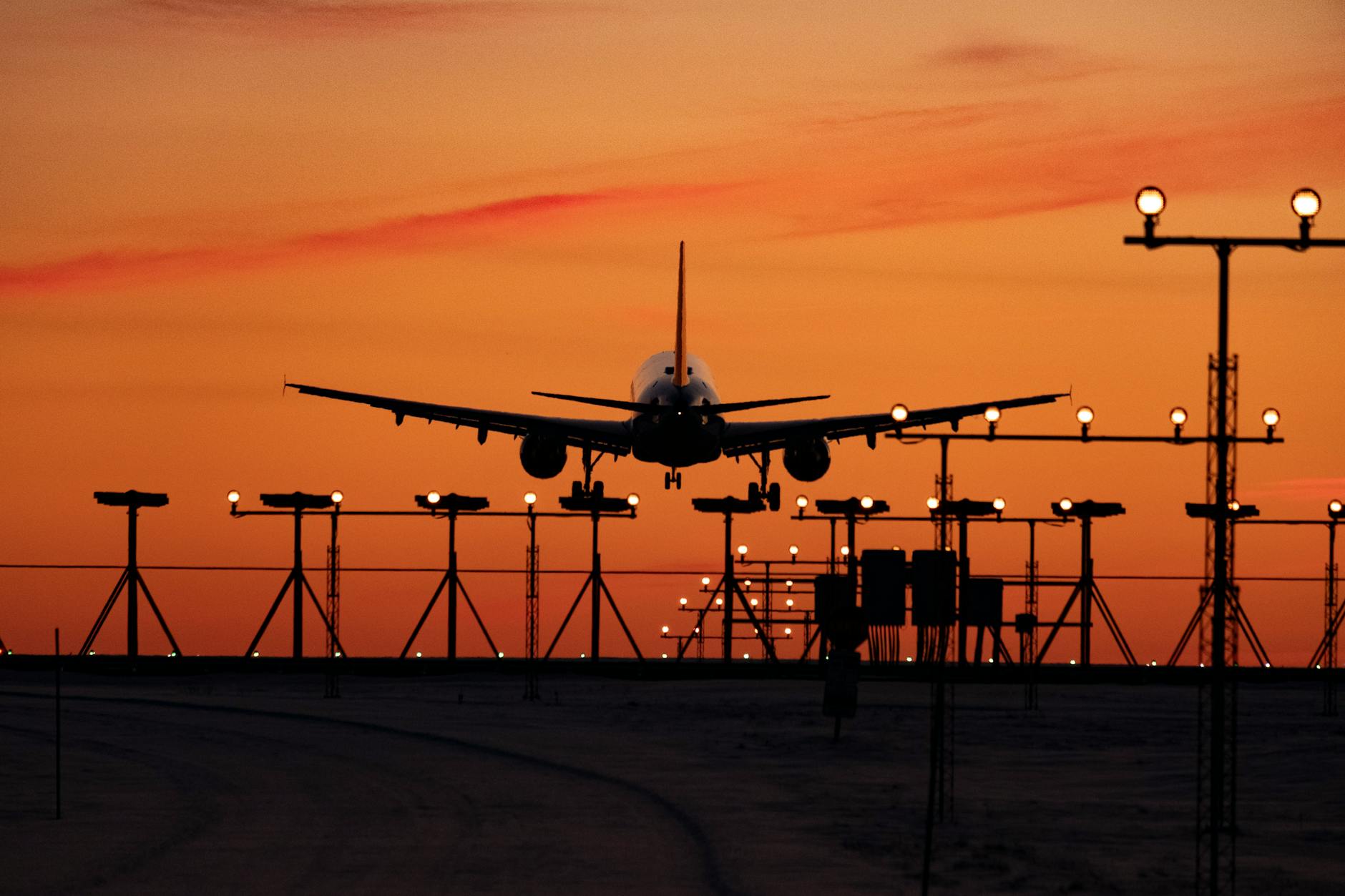 airplane landing at sunset silhouette scene