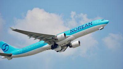 korean air plane taking off against blue sky