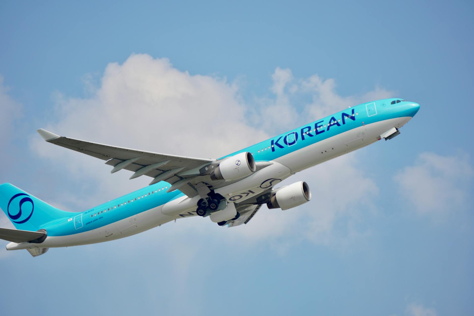 korean air plane taking off against blue sky