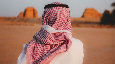 man in traditional attire in desert landscape