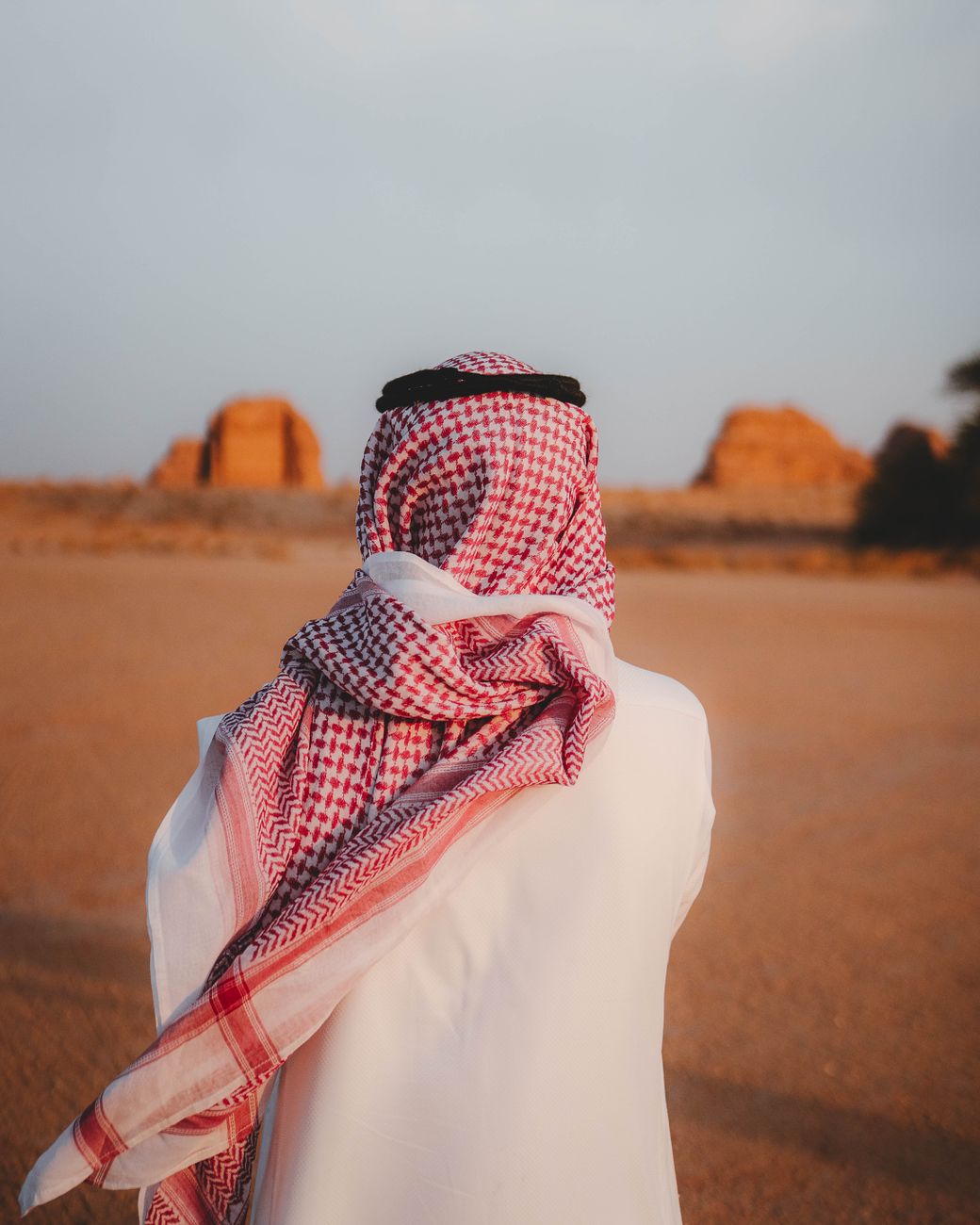 man in traditional attire in desert landscape