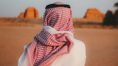 man in traditional attire in desert landscape