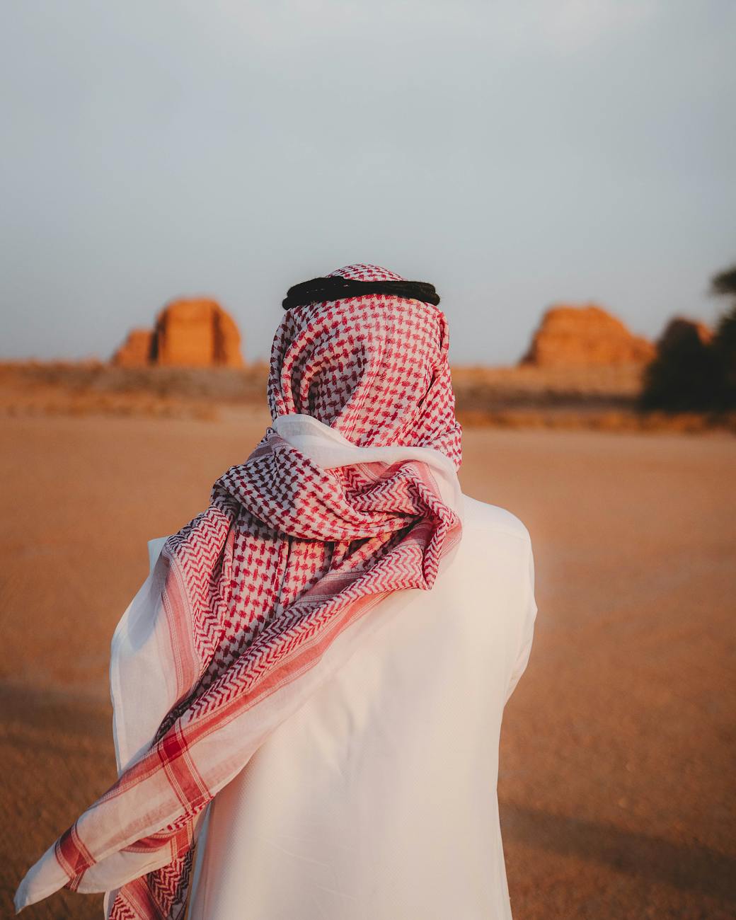 man in traditional attire in desert landscape