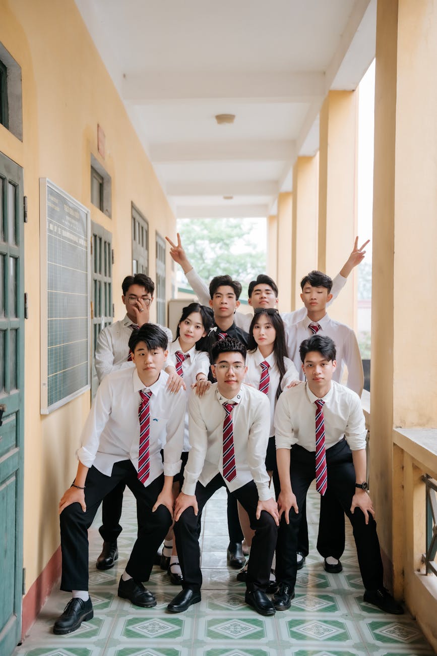 group of students posing in school corridor