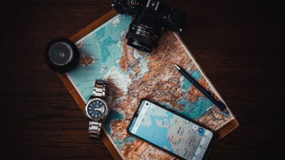 smartphone beside watch and camera