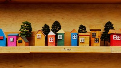 colorful wooden miniature houses on shelf