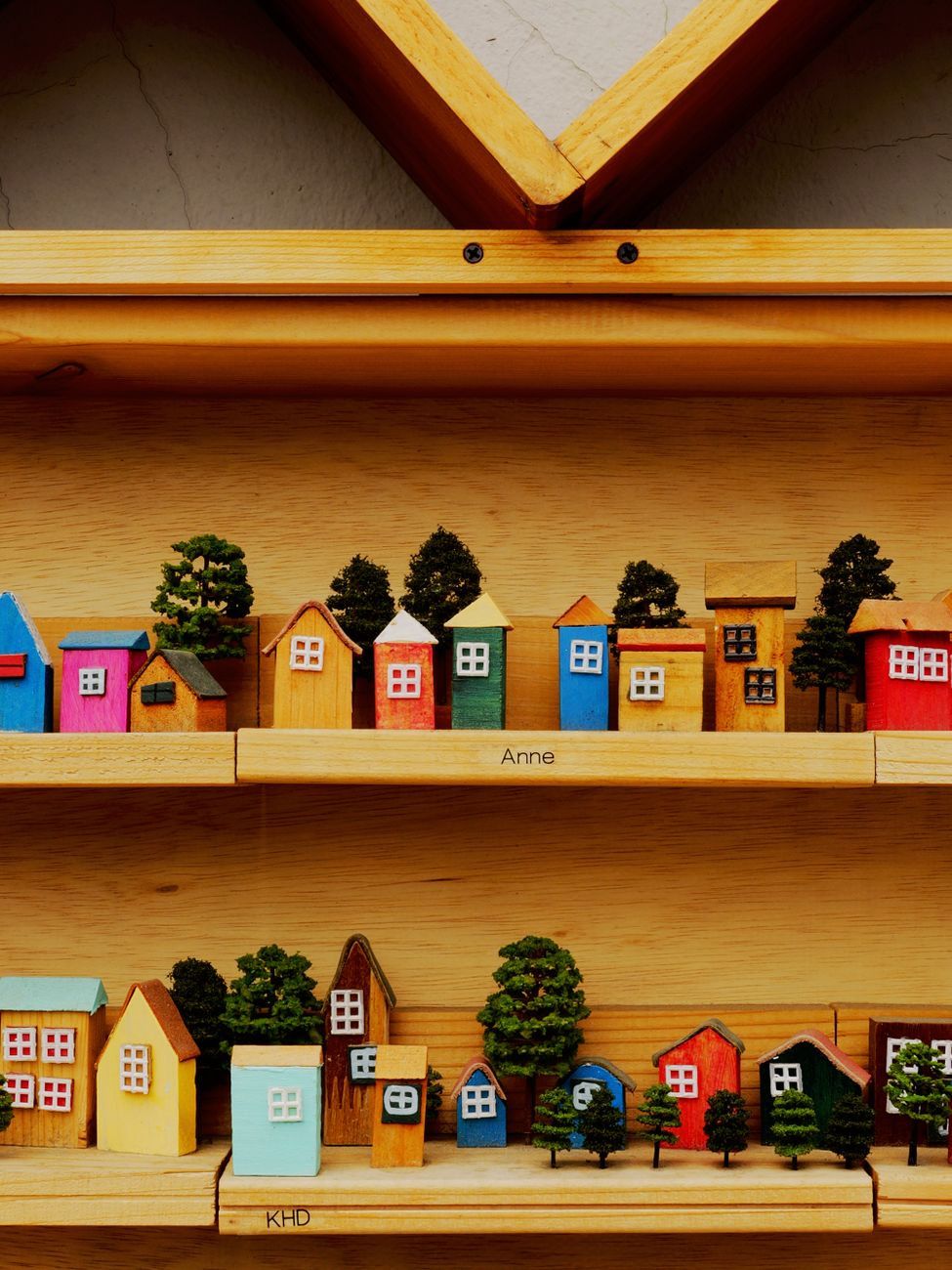 colorful wooden miniature houses on shelf
