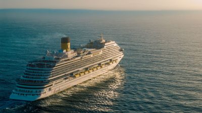 majestic cruise ship sailing on open ocean at sunset