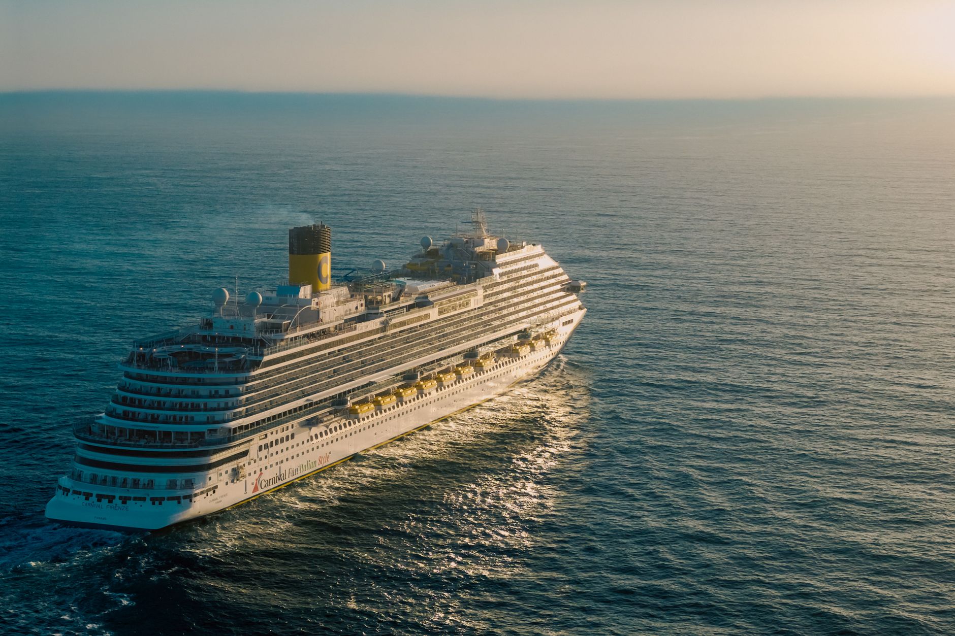 majestic cruise ship sailing on open ocean at sunset