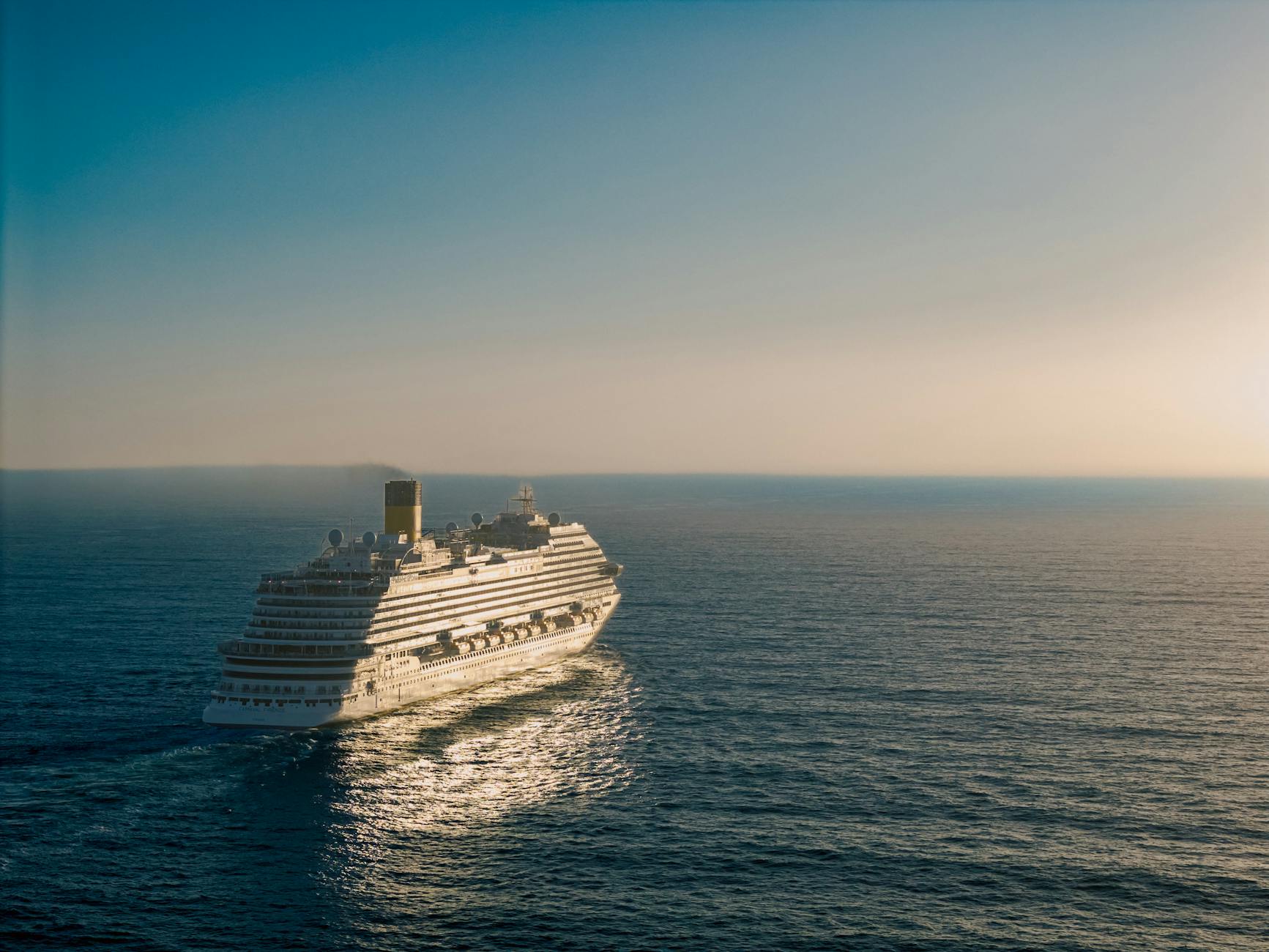 luxurious cruise ship sailing at sunset
