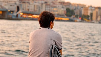pensive moment by the waterside at sunset