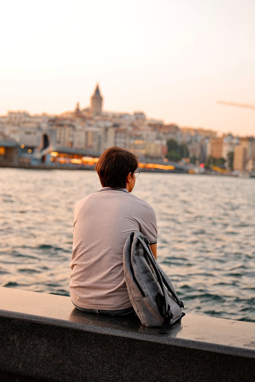 pensive moment by the waterside at sunset