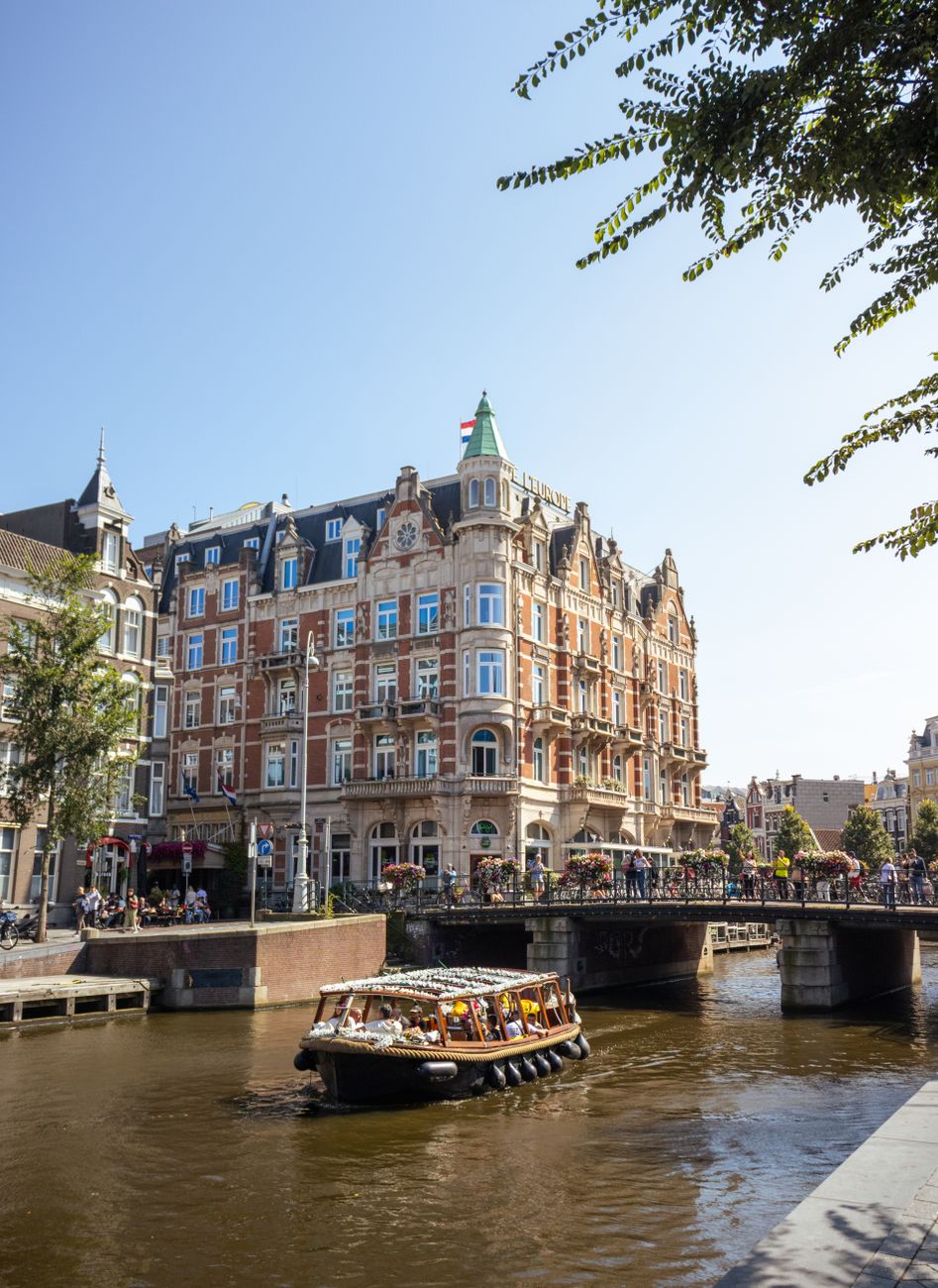 historic amsterdam canal with bustling bridge scene