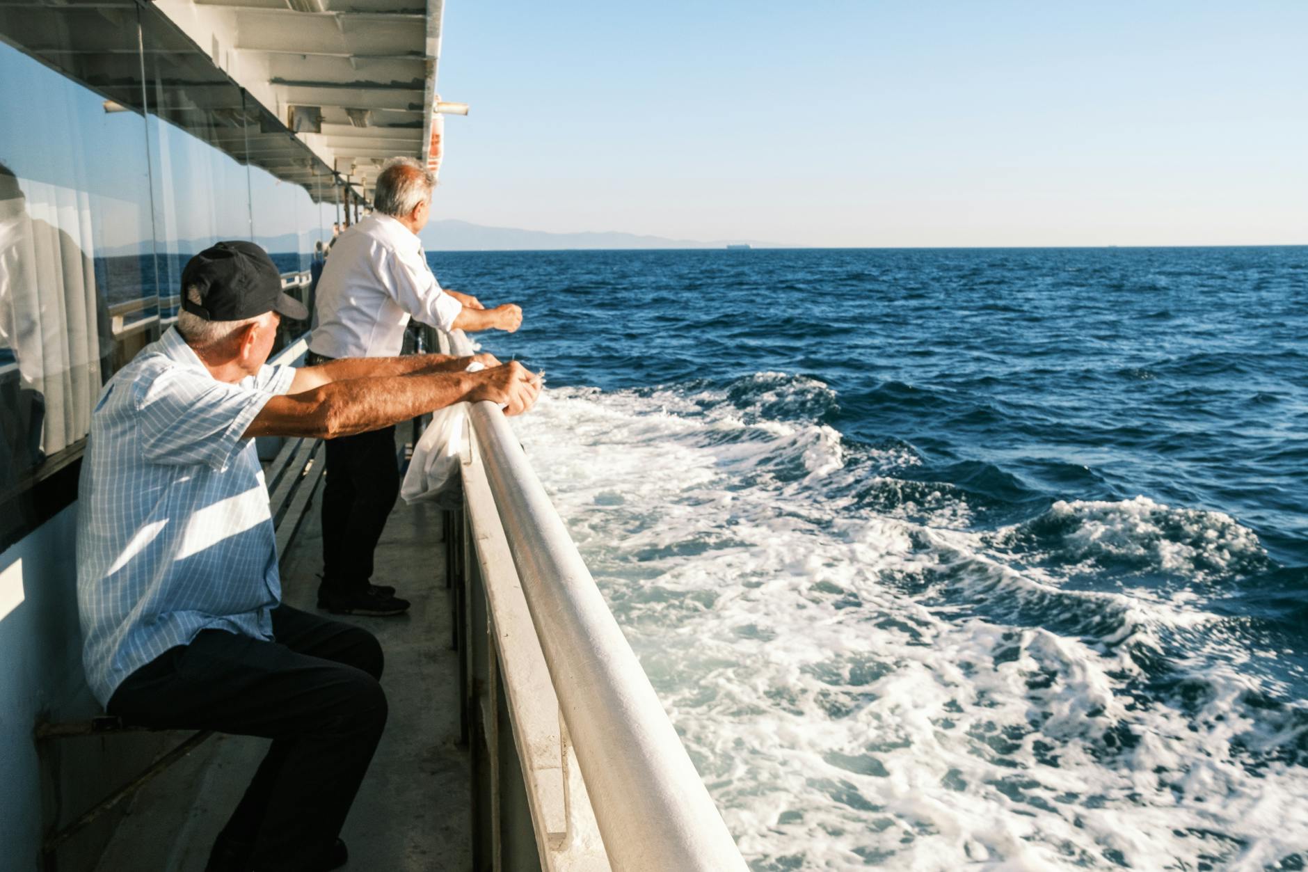 senior men enjoying scenic sea view from ferry