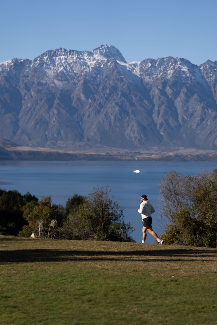 jogger in scenic landscape of queenstown new zealand