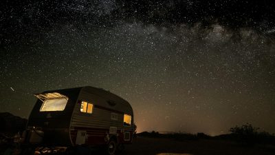 starry night sky above vintage camper