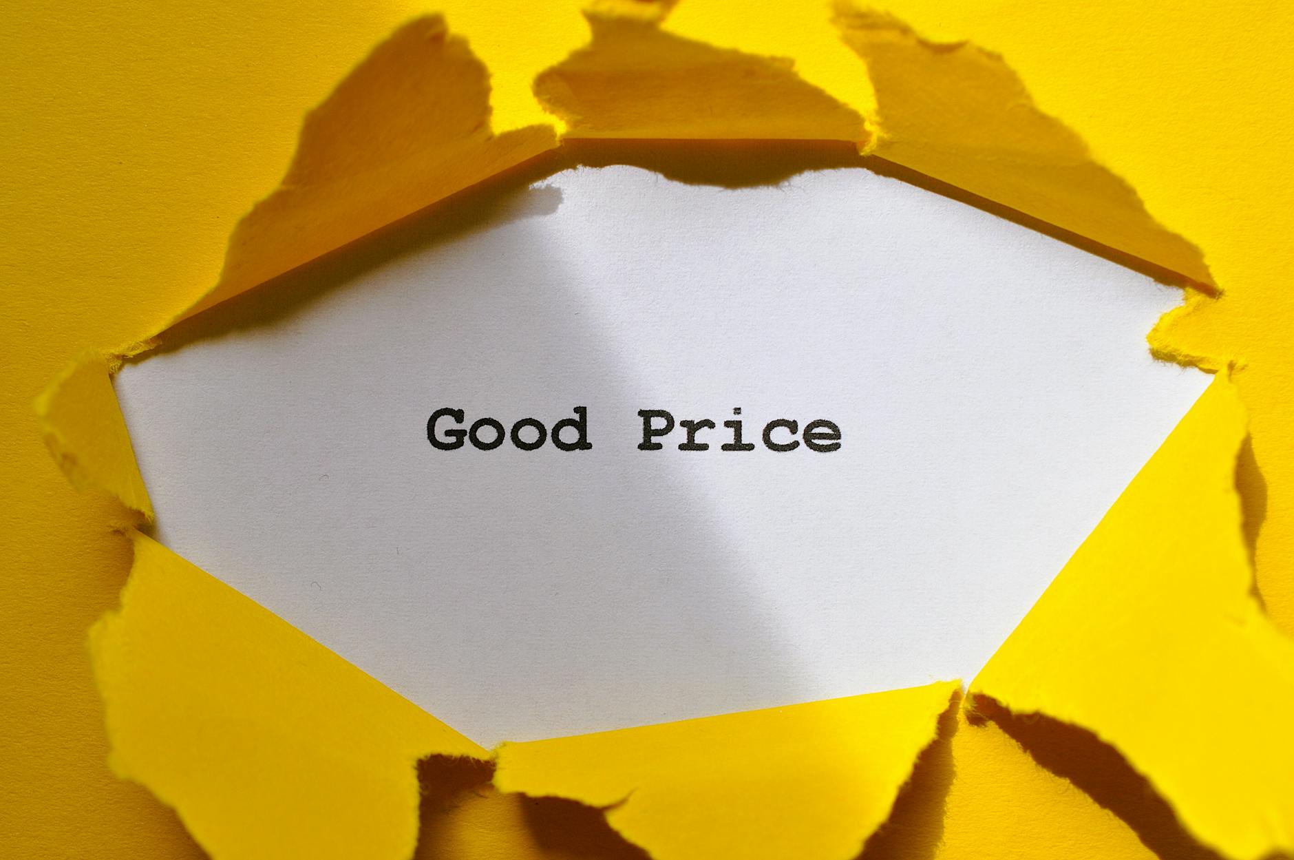 torn yellow paper revealing good price message
