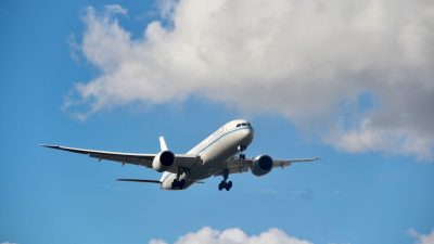 commercial airplane flying in clear blue sky