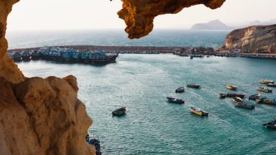 scenic cove with vibrant boats at sunset