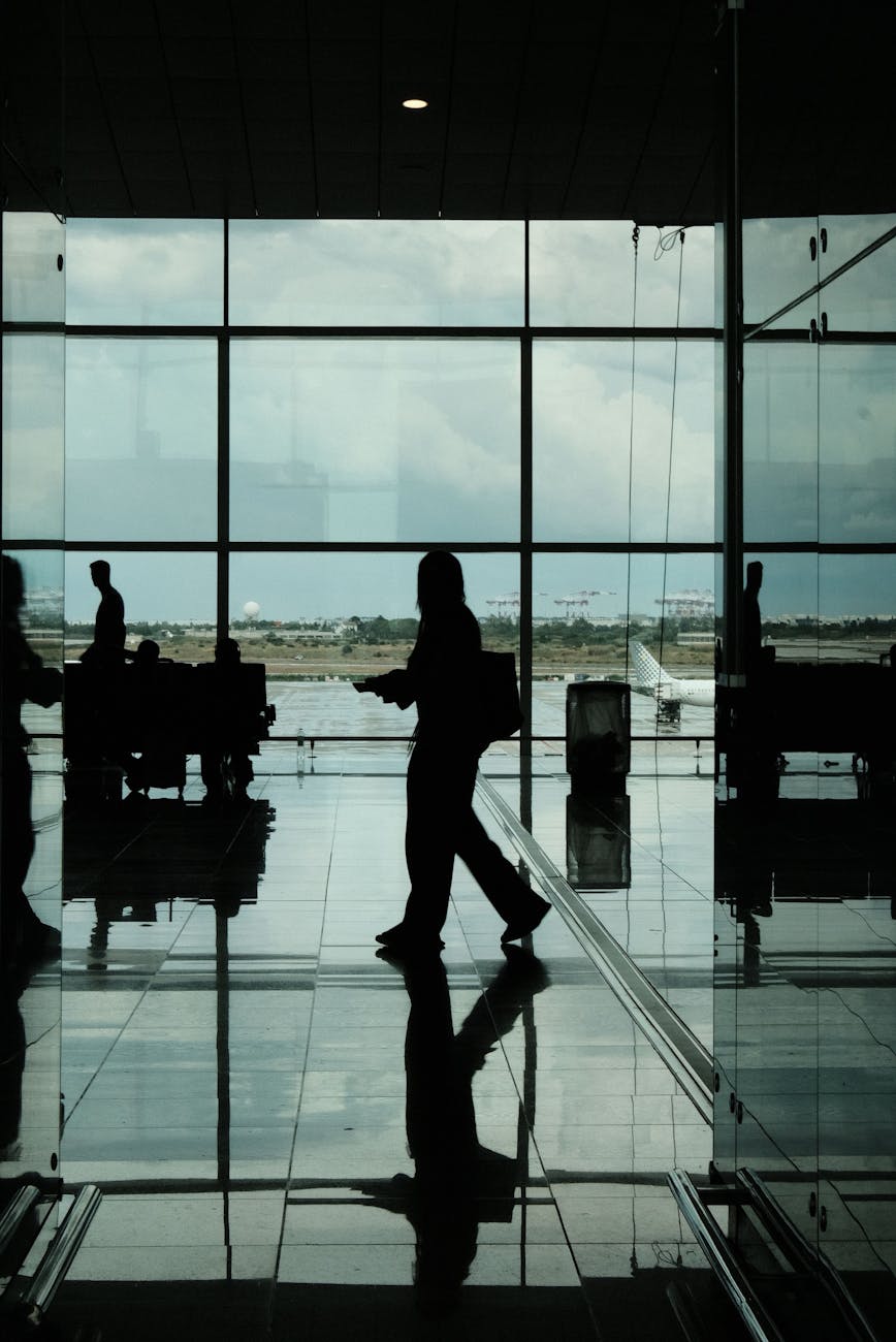silhouetted travelers in barcelona airport terminal
