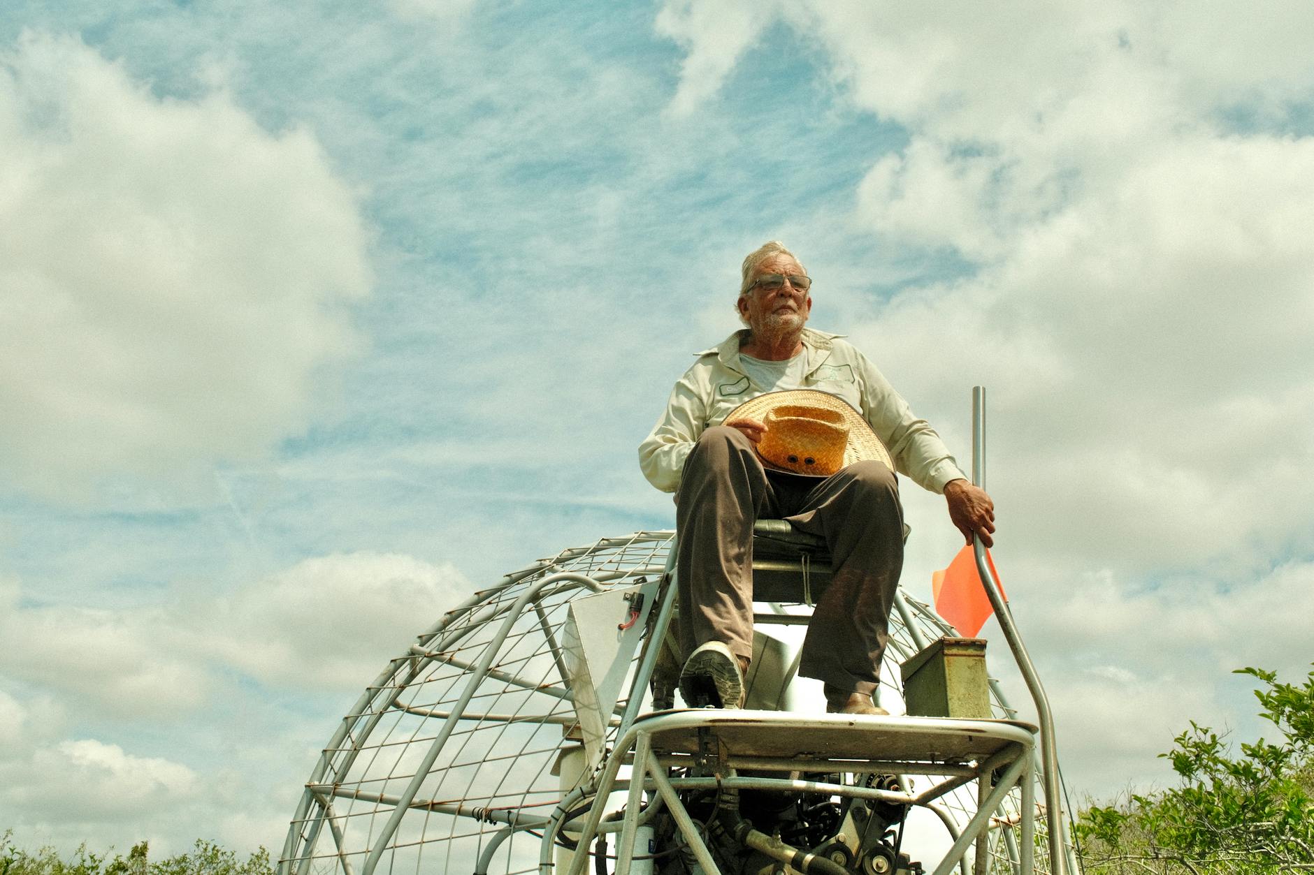senior man on airboat exploring the florida everglades