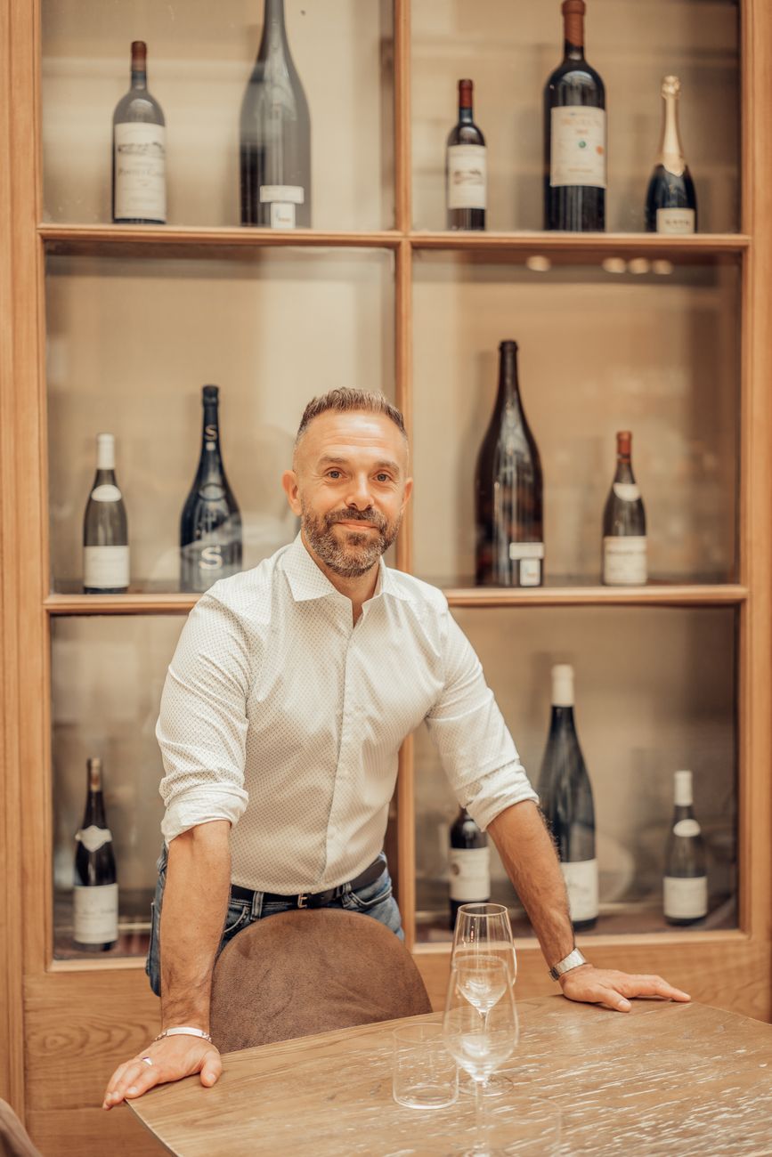 elegant man posing in paris wine cellar