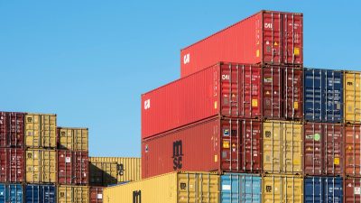 stack of colorful shipping containers against blue sky