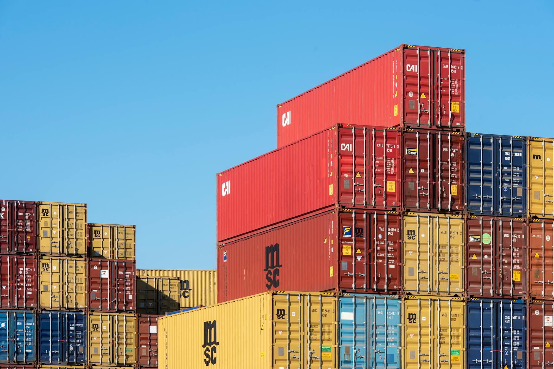 stack of colorful shipping containers against blue sky