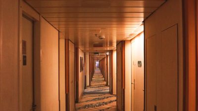 warmly lit empty cruise ship corridor