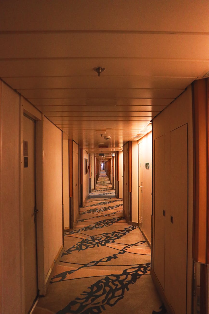 warmly lit empty cruise ship corridor