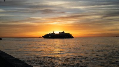 cruise ship at sunrise on the tagus river lisbon