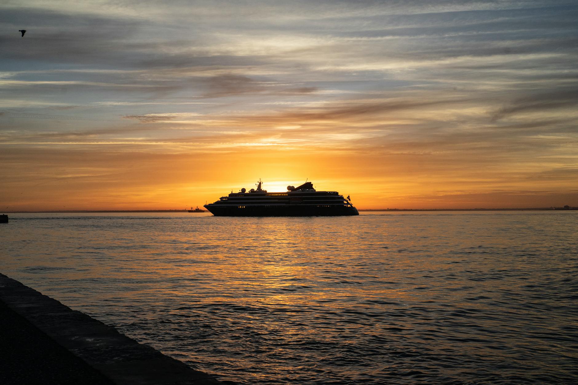 cruise ship at sunrise on the tagus river lisbon