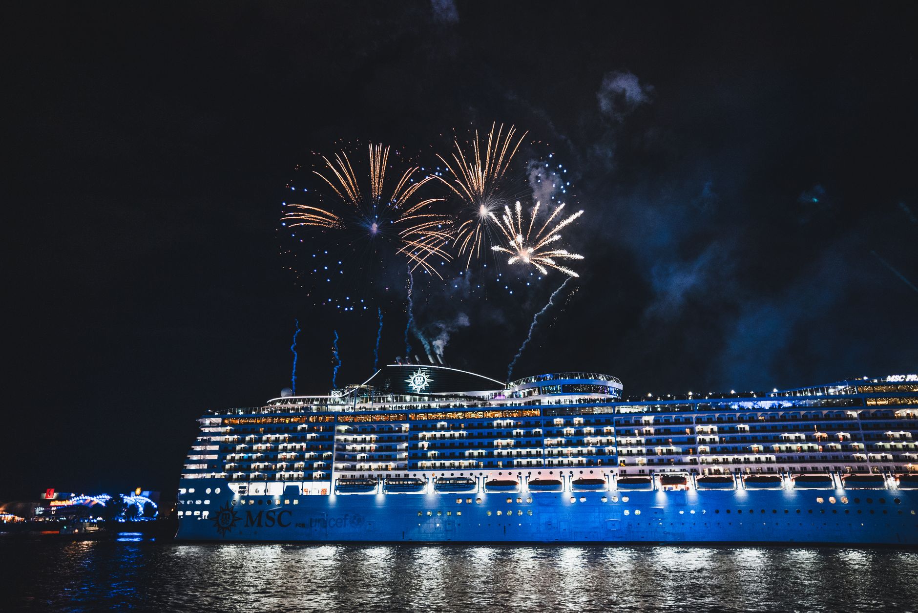 fireworks illuminate cruise ship at night