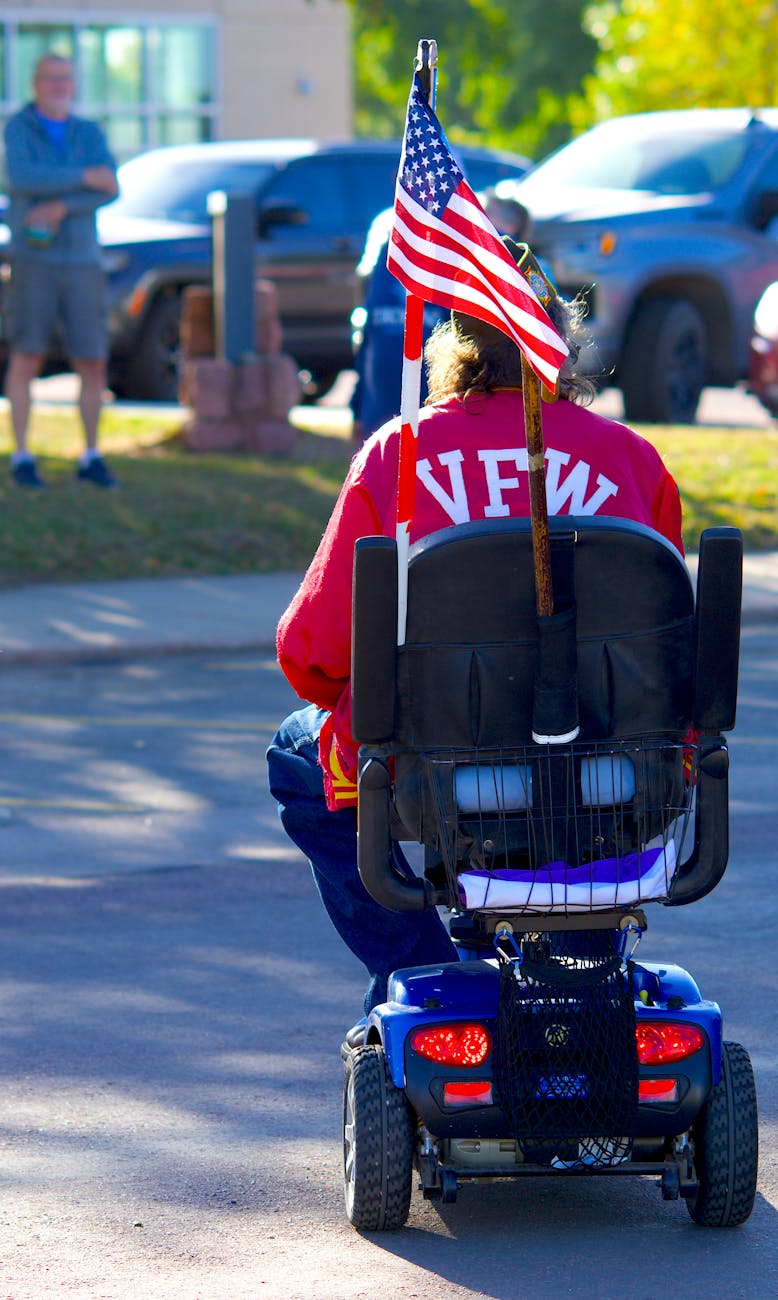 veteran on mobility scooter with american flag