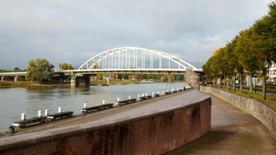 sunny riverside view of iconic bridge at arnhem