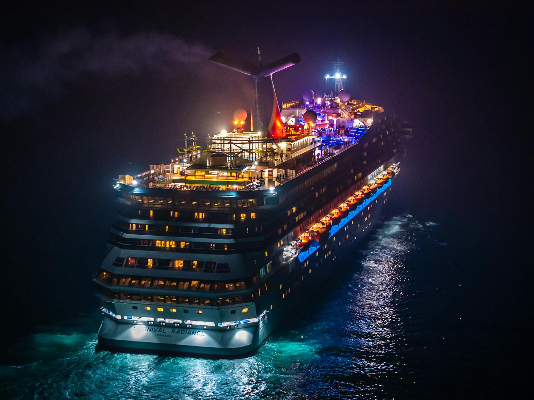 aerial view of illuminated cruise ship at night