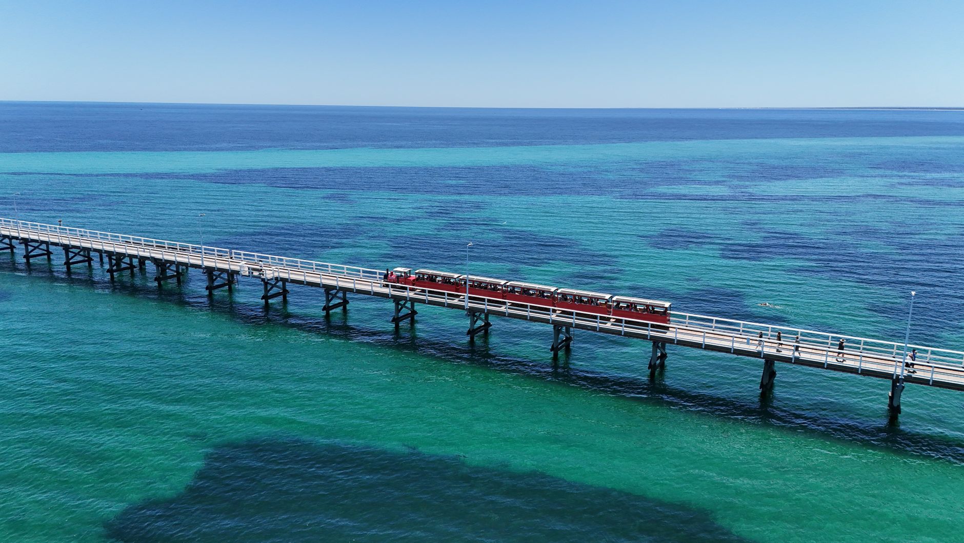 busselton jetty with red train in western australia