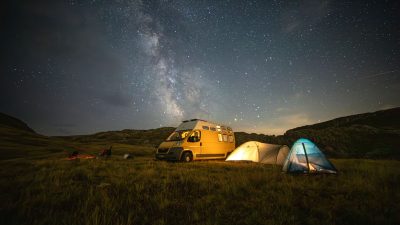 starry night camping adventure with van and tents