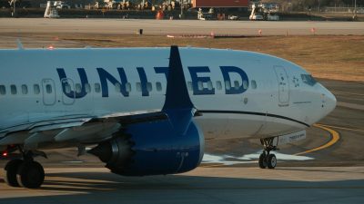 commercial airplane taxiing on airport runway