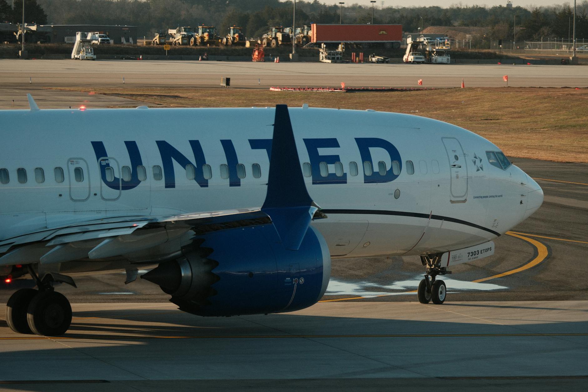 commercial airplane taxiing on airport runway